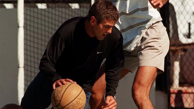 Actor George Clooney enjoying a game of one-on-one at Sheraton Mirage's basketball court with employee Julien Petit in June, 1997.