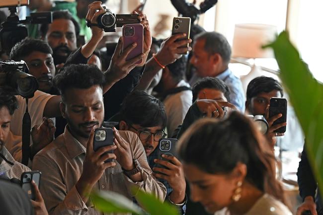 A group of paparazzi take pictures and videos of Bollywood actress Sara Ali Khan, outside a hotel in Mumbai