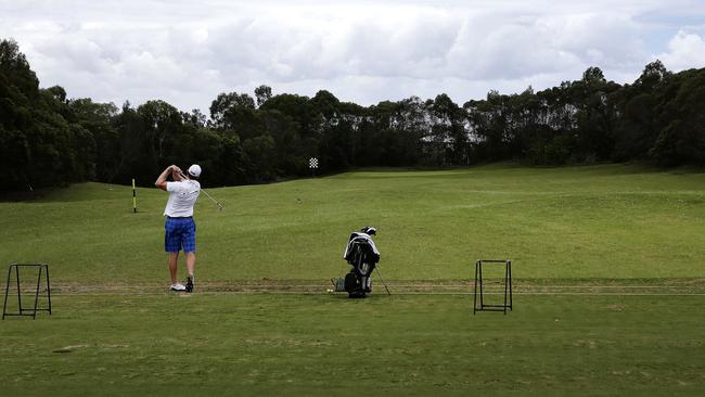 A golfer on the range at North Lakes golf Course in 2014. Photo by Andrew Seymour