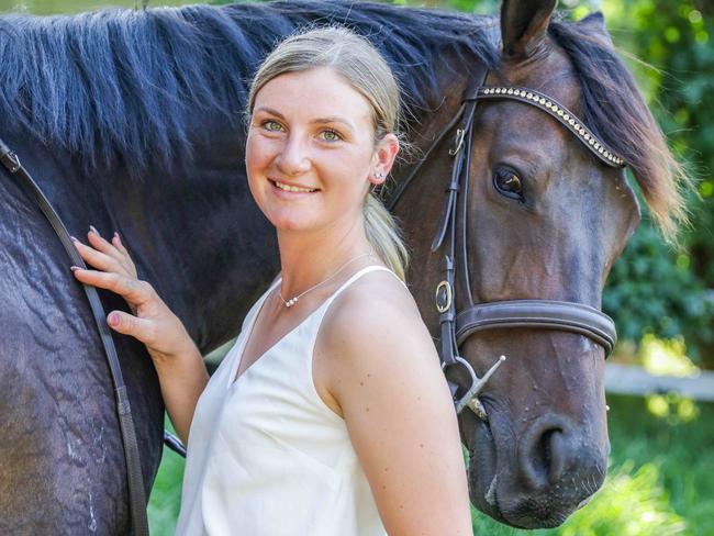 Jamie Kah, 23, is one of Australia's leading jockeys. Here with Brax, former race horse which she is retraining into a show jumping horse. Picture- Nicole Cleary