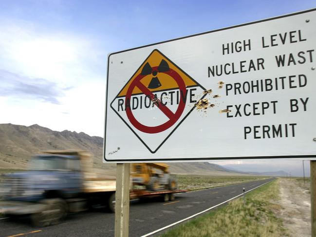 Shotgun holes in radioactive nuclear waste warning road sign along highway leading to Goshute Indian Tribe reservation in Skull Valley, Utah 03 May 2006 - caution signs damage vandalism High Level Prohibited Except by Permit Radioactive