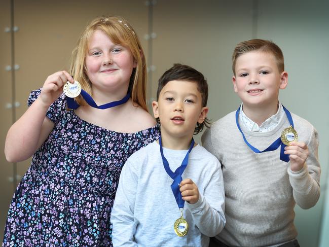 Junior Triple Zero Heroes Jorja Gardiner, 8, Ace Cope, 6, and Miles Taylor, 7, with their medals. Picture: David Caird