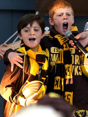 Best mates Levi Page, left, of Lenah Valley, and Aleck Evans, of Glenorchy, sing the Hawthron Football Club song for the crowd at Princes Wharf. Picture: SAM ROSEWARNE