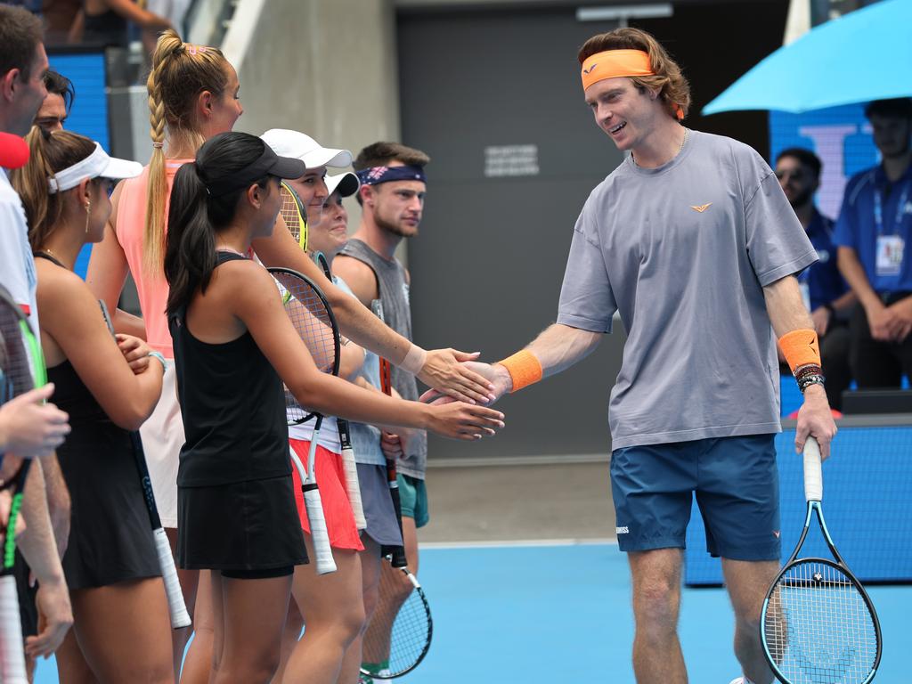 Andrey Rublev high-fives amateur players before the tournament. Picture: David Caird