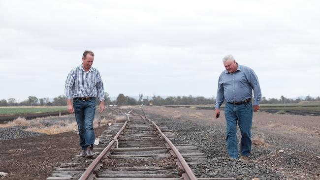 Jason Mundt (left) and Wes Judd (right) inspect the damaged rail line near Gilgai Lane, outside Pampas. The line was hit by the 2010, 2011, and 2013 floods.