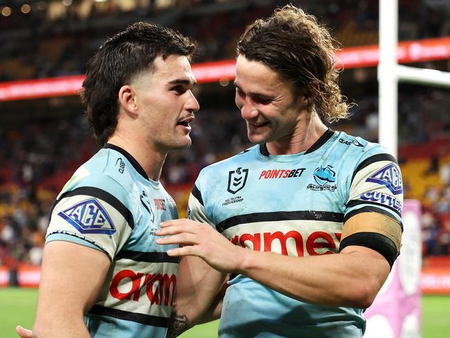 BRISBANE, AUSTRALIA - MAY 18: Daniel Atkinson and Nicho Hynes of the Sharks celebrate victory during the round 11 NRL match between Cronulla Sharks and Sydney Roosters at Suncorp Stadium, on May 18, 2024, in Brisbane, Australia. (Photo by Hannah Peters/Getty Images)