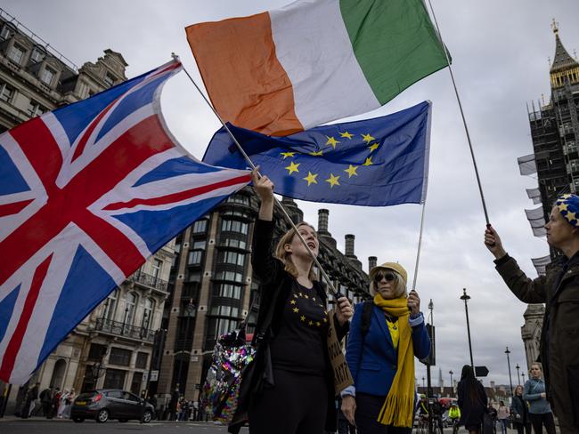 LONDON, ENGLAND - OCTOBER 13: Anti-Brexit protesters wave the flags of the United Kingdom, Ireland and European Union outside Parliament on October 13, 2021 in London, England. (Photo by Rob Pinney/Getty Images)