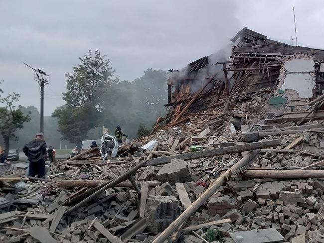 This handout picture taken and released by Ukrainian Emergency service shows firefighters removing rubble from a destroyed building after a missile strike in the city of Nikopol. Picture: AFP