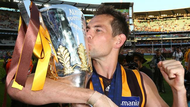 Hodge kisses the premiership cup after the 2014 Grand Final against Sydney. Picture: Michael Klein