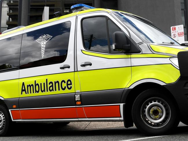 BRISBANE, AUSTRALIA - NewsWire Photos - JANUARY 13, 2021.An Ambulance leaves the Hotel Grand Chancellor in Spring Hill, Brisbane. Guests will be evacuated after six people linked to the building tested positive to the highly-contagious UK variant of the coronavirus.Picture: NCA NewsWire / Dan Peled