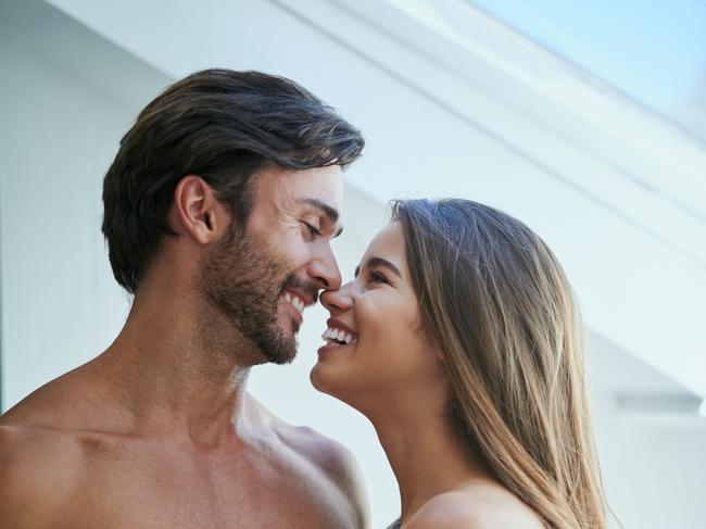 Shot of an affectionate young couple kissing at home