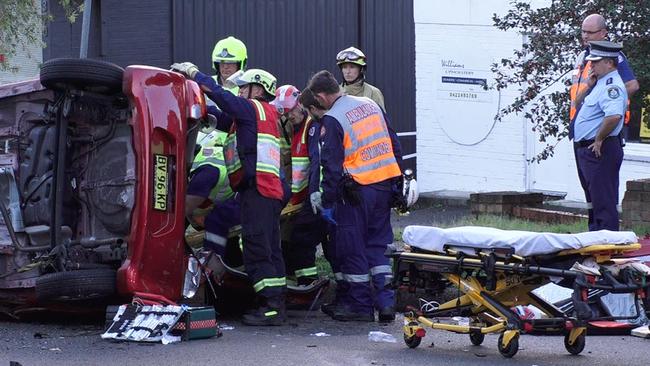 Emergency services attend to aged care nurse Kay Shaylor after the crash at North Gosford. Picture: Digicrew Australia