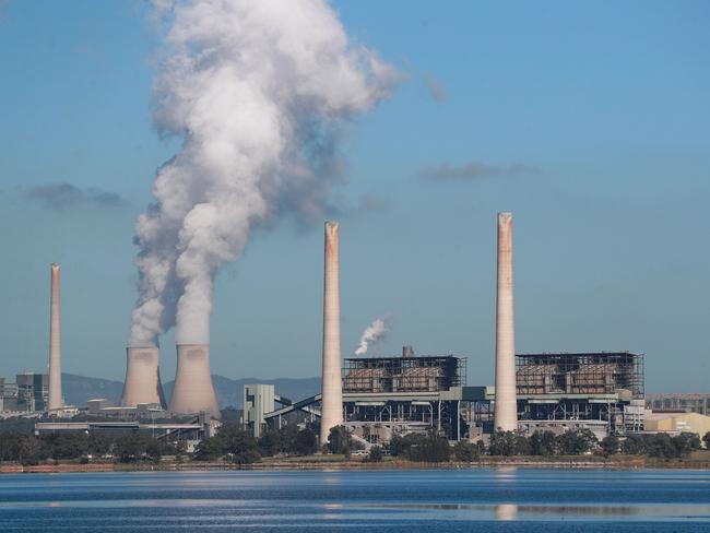 MUSWELLBROOK, AUSTRALIA - APRIL 27: Liddell Power Station stands next to Lake Liddell as chimneys at the Bayswater Power Station seen emit water vapour on April 27, 2023 in Muswellbrook, Australia. Liddell Power Station, one of Australia's oldest coal-fired power plants, will shut down on Friday, 28 April, after 52 years in operation. The AGL-owned facility opened in 1971 and was once the most powerful generating station in Australia. With Australia making the transition from coal power to renewables, the site will be transformed into a new low-carbon industrial energy hub. Demolition of the plant will begin next year, with more than 90 per cent of the materials to be recycled, AGL says. The closure of Liddell Power Station will stop 8 million tonnes of Carbon dioxide being released into the atmosphere every year, media reported. (Photo by Roni Bintang/Getty Images)