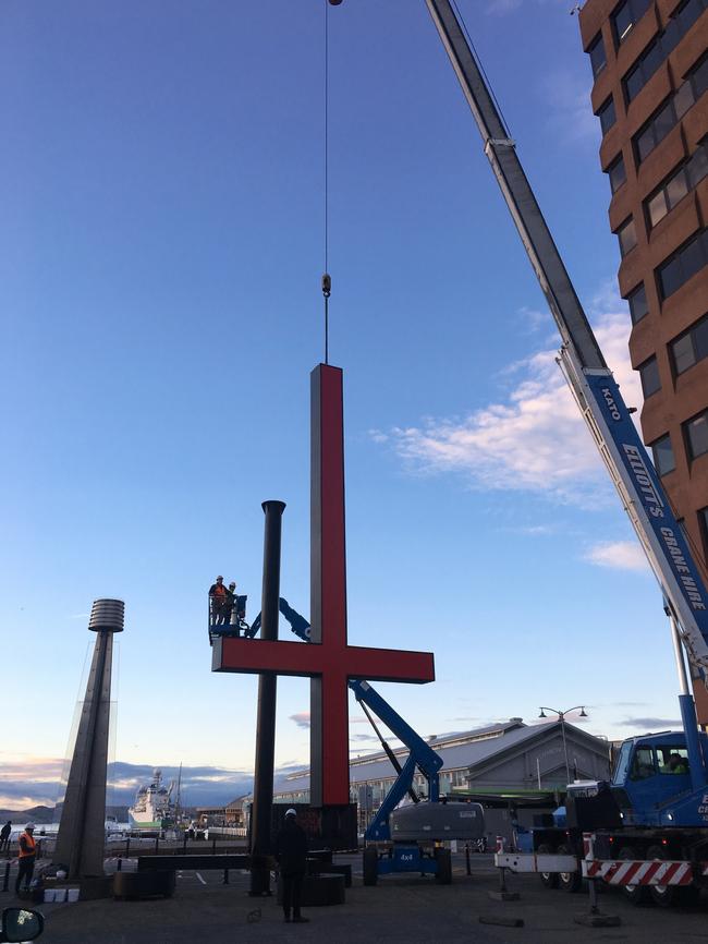 Inverted crosses being removed from the Hobart waterfront earlier today.