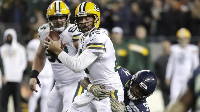 Green Bay Packers quarterback Aaron Rodgers is sacked by Seattle Seahawks defensive end Rasheem Green. (AP Photo/Elaine Thompson)