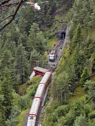 A helicopter flies over the train after it was derailed by a landslide. Picture: Michael Buholzer