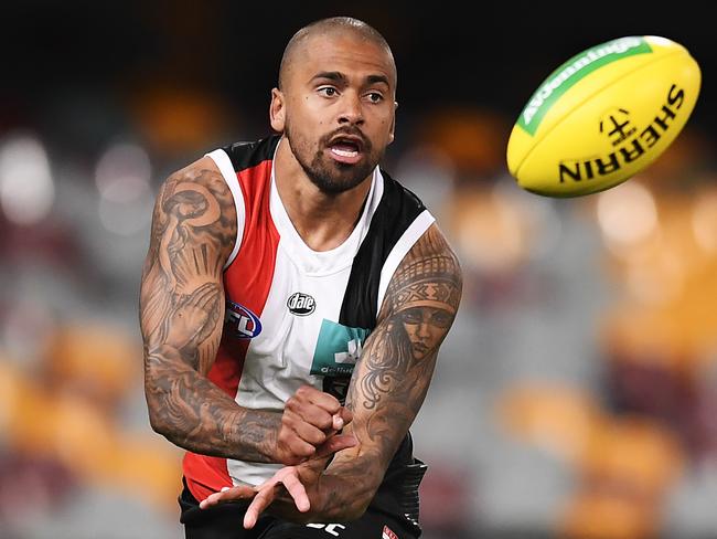 BRISBANE, AUSTRALIA - AUGUST 10: Brad Hill of the Saints handballs during the round 11 AFL match between the St Kilda Saints and the Geelong Cats at The Gabba on August 10, 2020 in Brisbane, Australia. (Photo by Albert Perez/Getty Images)