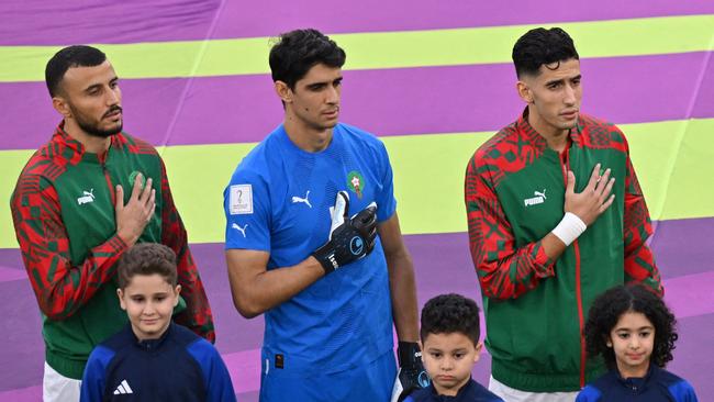 Morocco's goalkeeper #01 Yassine Bounou (C) sings the national anthem