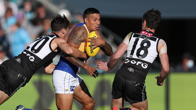 Connor Rozee and Zak Butters close in on star Eagle Tim Kelly. Picture: Sarah Reed/AFL Photos