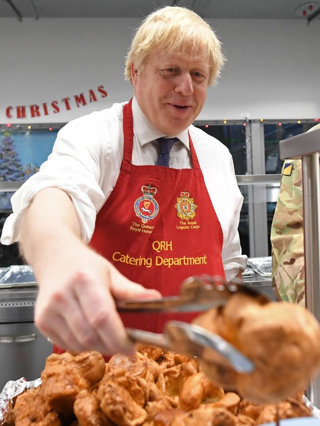 Mr Johnson serves Christmas lunch to British troops stationed in Estonia at the Tapa military base on December 21, 2019. Picture: AFP