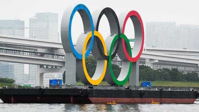 The Olympic rings in Tokyo Bay, like the Games themselves, remain afloat for the time being. Picture: Akio Kon/Bloomberg via Getty Images