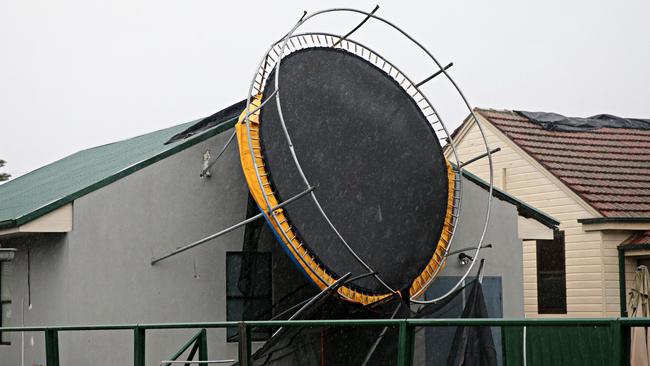 A trampoline was flung into the side of a house in Chester Hill. Picture: Adam Yip