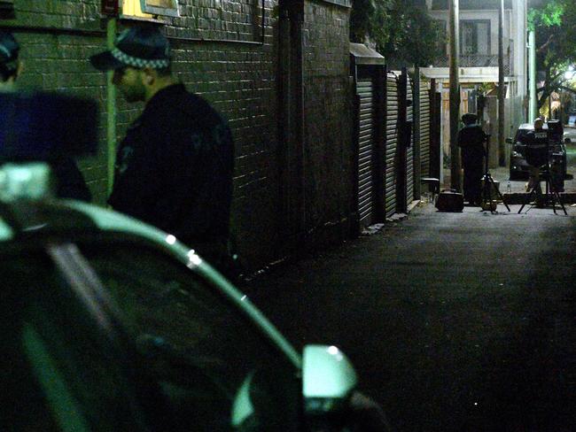 Police work in a lane way behind a house raided during terror raids in the inner Sydney suburb of Surry Hills last night. Picture: William West/AFP