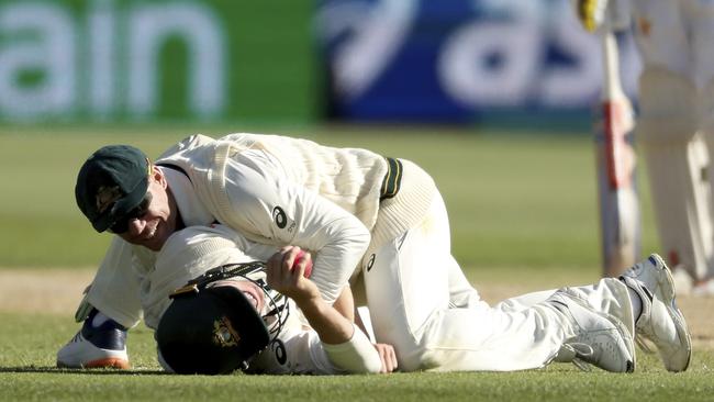 David Warner, top, celebrates after Marnus Labuschagne caught Iftikhar late on day four. Picture: AP/James Elsby