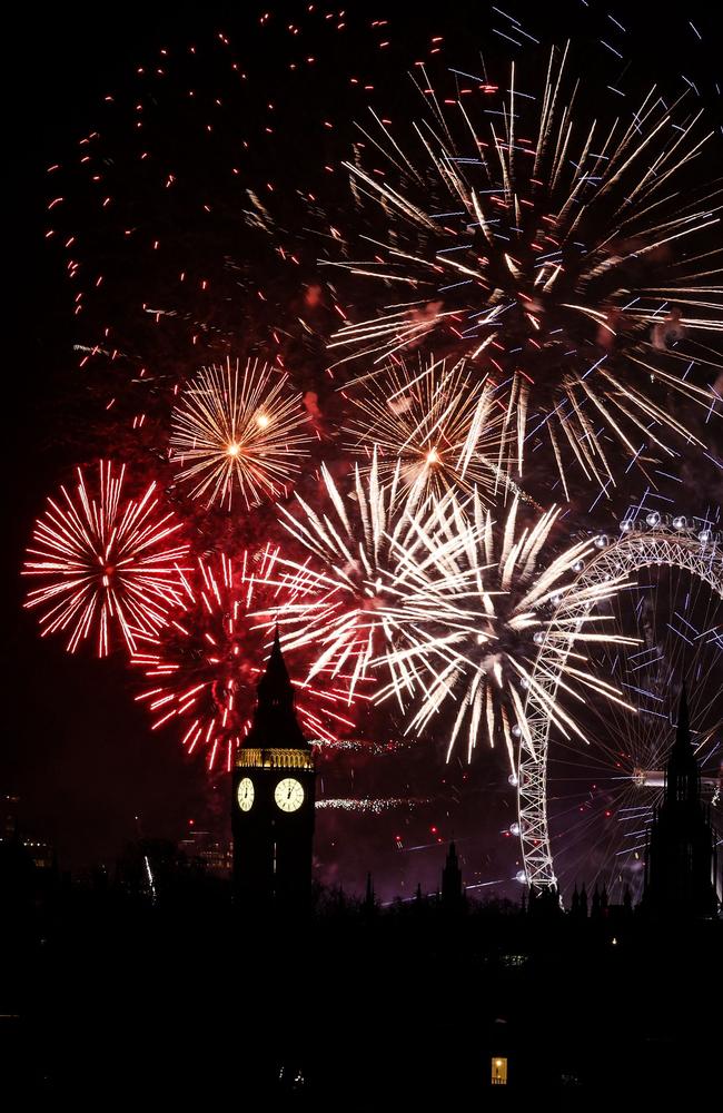 Fireworks explode in the sky around the London Eye and The Elizabeth Tower, commonly known by the name of the clock's bell, "Big Ben". Picture: AFP