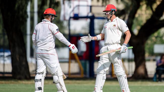 Patrick Page and Ben Pengelley shake hands as Page reached 50 against Kensington earlier this month. Picture: AAP/Morgan Sette