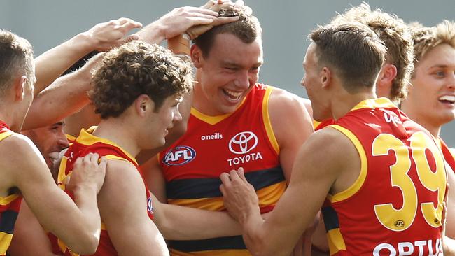 LAUNCESTON, AUSTRALIA - APRIL 25: Riley Thilthorpe of the Crows (C) celebrates a goal during the round six AFL match between the Hawthorn Hawks and the Adelaide Crows at University of Tasmania Stadium on April 25, 2021 in Launceston, Australia. (Photo by Daniel Pockett/Getty Images)