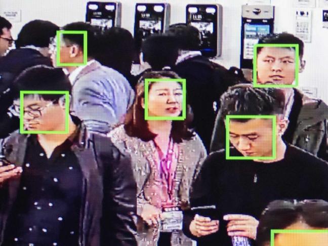 A screen shows visitors being filmed by AI (Artificial Inteligence) security cameras with facial recognition technology at the 14th China International Exhibition on Public Safety and Security at the China International Exhibition Center in Beijing on October 24, 2018. (Photo by NICOLAS ASFOURI / AFP)