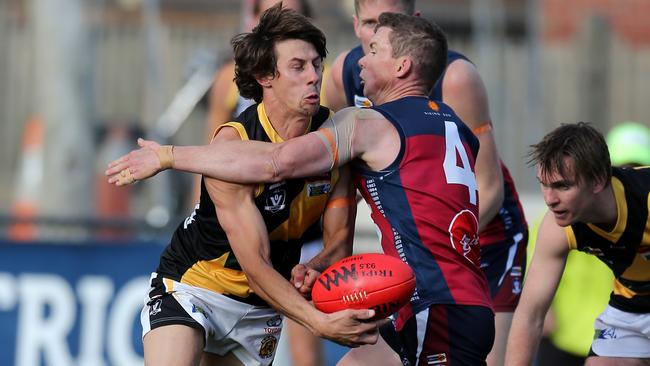 Rhys Magin fires out a handball for Kyneton. Picture: Yuri Kouzmin