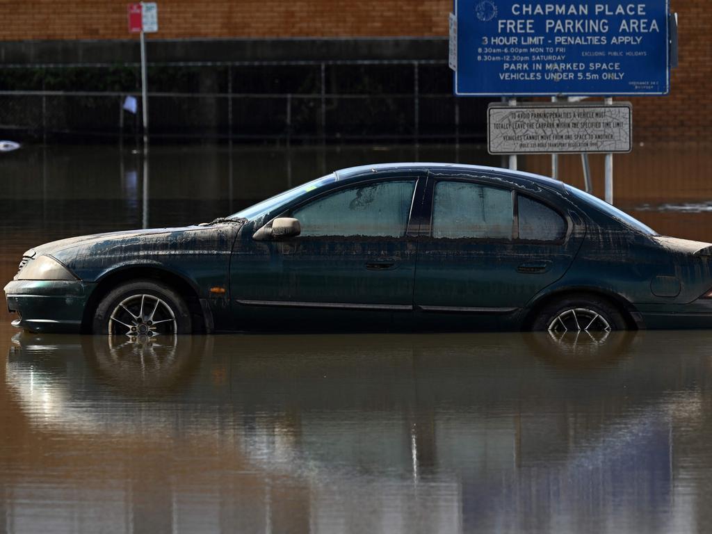 A car sits submerged in flood water. Picture: AFP
