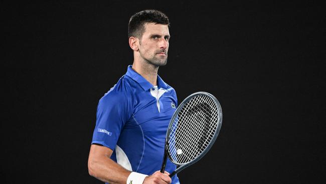 TOPSHOT - Serbia's Novak Djokovic celebrates after victory against Argentina's Tomas Etcheverry during their men's singles match on day six of the Australian Open tennis tournament in Melbourne on January 19, 2024. (Photo by WILLIAM WEST / AFP) / -- IMAGE RESTRICTED TO EDITORIAL USE - STRICTLY NO COMMERCIAL USE --