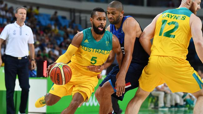 Australia's guard Patty Mills works around France's small forward Nicolas Batum.