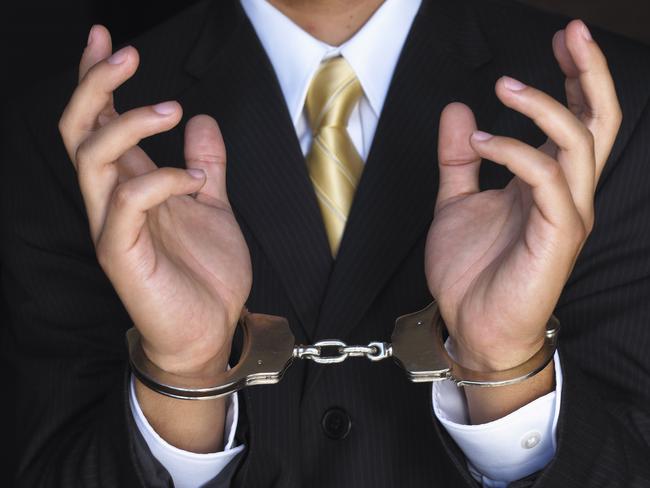 Handcuffed hands of businessman. Crime, arrest, corporate, generic