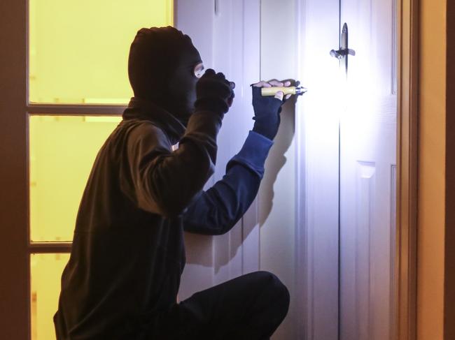 Unrecognizable male burglar breaking into a house. istock burglar