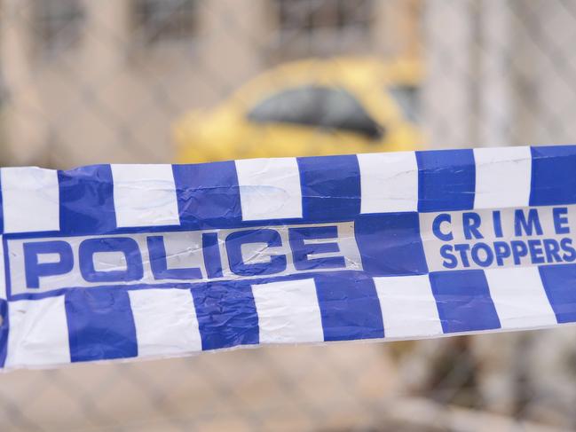 Blue and white Police tape cordoning off a area with a yellow car at a industrial area, Australia 2016Police tape cordoning off a area with a yellow car - Stock image  ipad generic