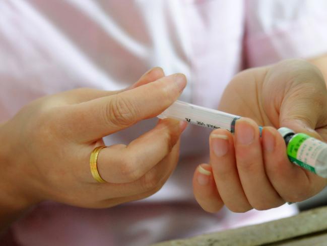 A nurse preparing a vaccination injection.