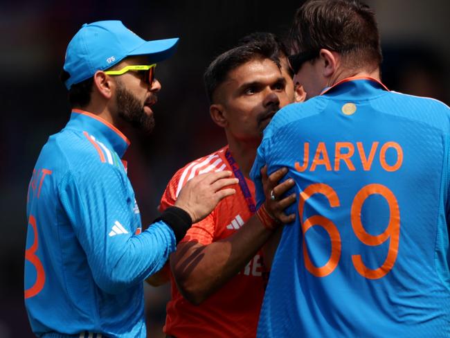 CHENNAI, INDIA - OCTOBER 08: Virat Kohli of India speaks to a pitch invader prior to the ICC Men's Cricket World Cup India 2023 between India and Australia at MA Chidambaram Stadium on October 08, 2023 in Chennai, India. (Photo by Robert Cianflone/Getty Images)