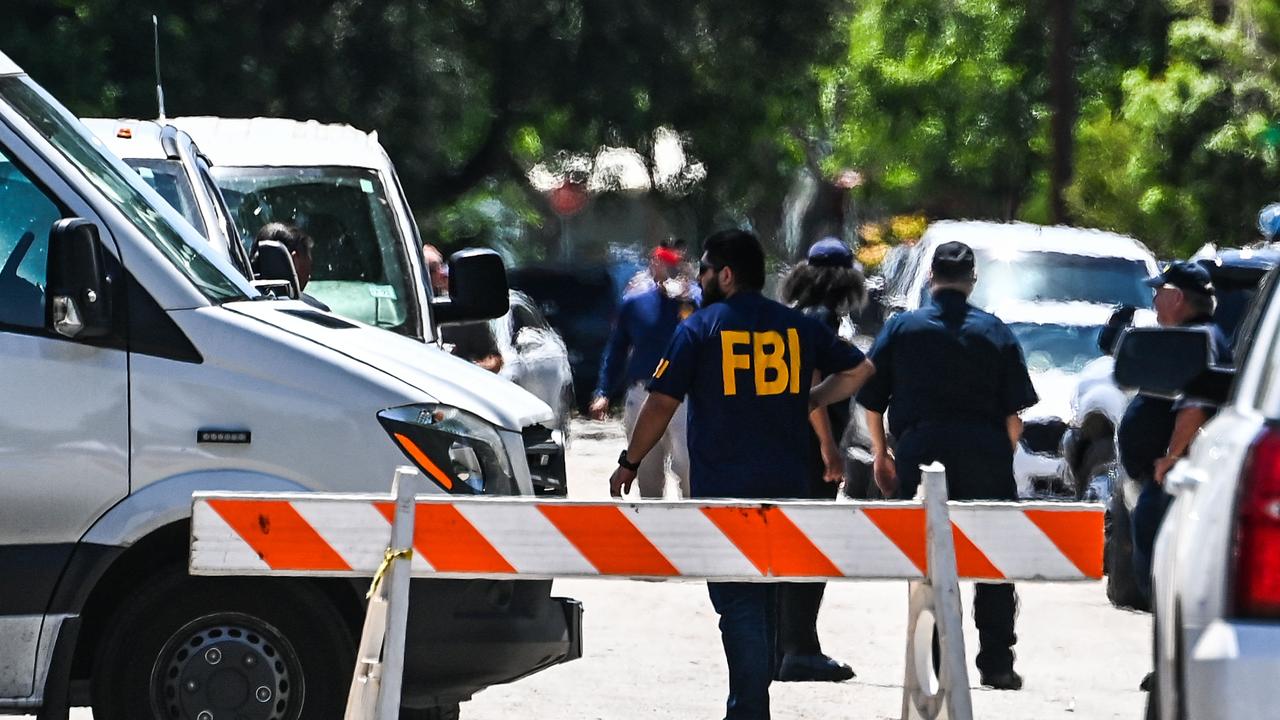 An FBI agent outside Robb Elementary School in Uvalde, Texas. Picture: Chandan Khanna / AFP