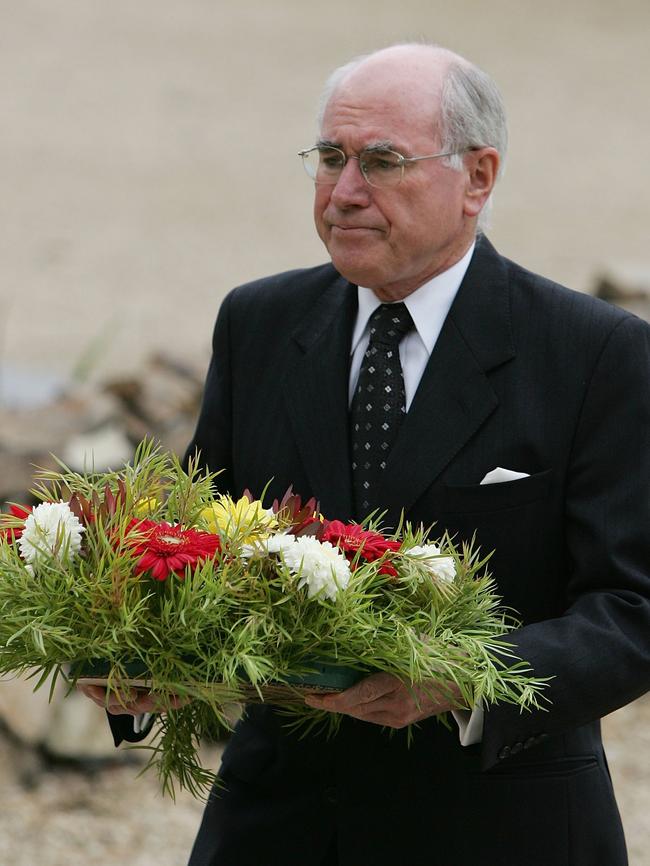 Then prime minister John Howard lays a wreath at the memorial site of the Port Arthur massacre during a memorial service to mark the 10th anniversary of the massacre in 2006. Picture: Ian Waldie/Getty Images