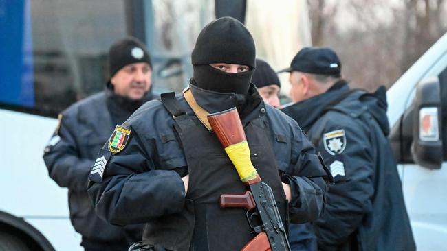 Members of a Ukrainian police unit stand guard in Solomonovo village, Ukraine, west of Chop, close to the Hungary-Ukraine borde. Picture: ATTILA KISBENEDEK / AFP)