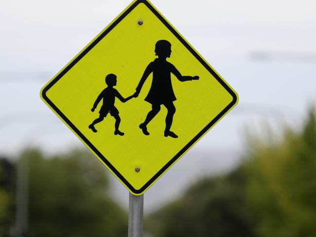 A school crossing sign is seen at Gillies St Primary in Adelaide, Friday, January 25, 2019. (AAP Image/Kelly Barnes) NO ARCHIVING