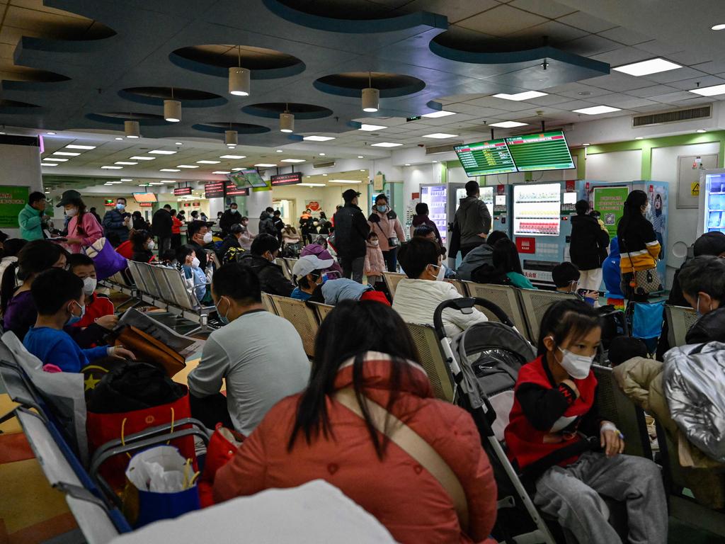 Children and their parents wait at an outpatient area at a children hospital in Beijing amid an outbreak of respiratory illness in children. Picture: AFP