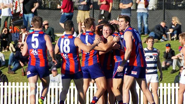 Port players surround Matt Signorello after his goal in the final quarter. Pic: Jenny Tserkezidis