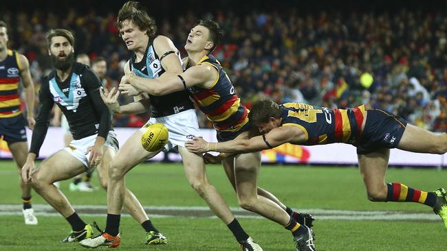 Adelaide’s Jake Lever tackled Port Adelaide’s Jared Polec in Showdown 43 at Adelaide Oval. Picture: Sarah Reed