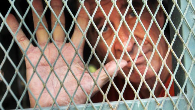 James Ricketson gestures from inside a prison truck in Cambodia earlier this year. Picture: AP