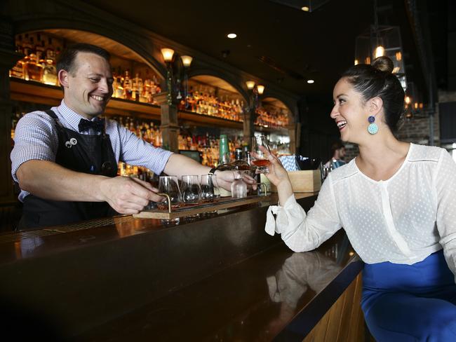 Glenn Wheeler withAlicia Hawkins at Nola, Barangaroo, today, tasting flavoured whisky.Picture: Justin Lloyd.